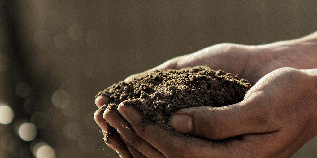 Microbiome Solutions for Soil Health-Image depicting hands holding soil