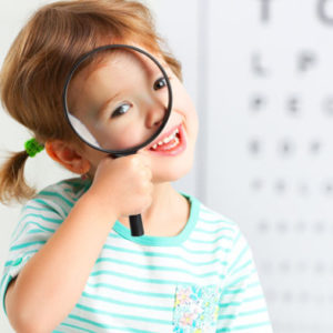 Novel Eye Drop Administration Techniques for pediatric phthalmology. Image depicts a young female child with a magnifying glass over one eye and a vision test target in the backgroung