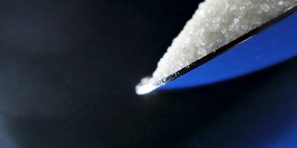 PepsiCo Seeking: Tech to Reduce Salt Perception of Electrolytes-Image of a spoon with salt crystals