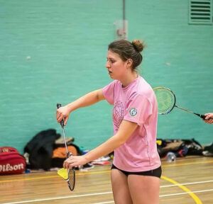 Emma Chapelhow preparing to serve in a game of badminton